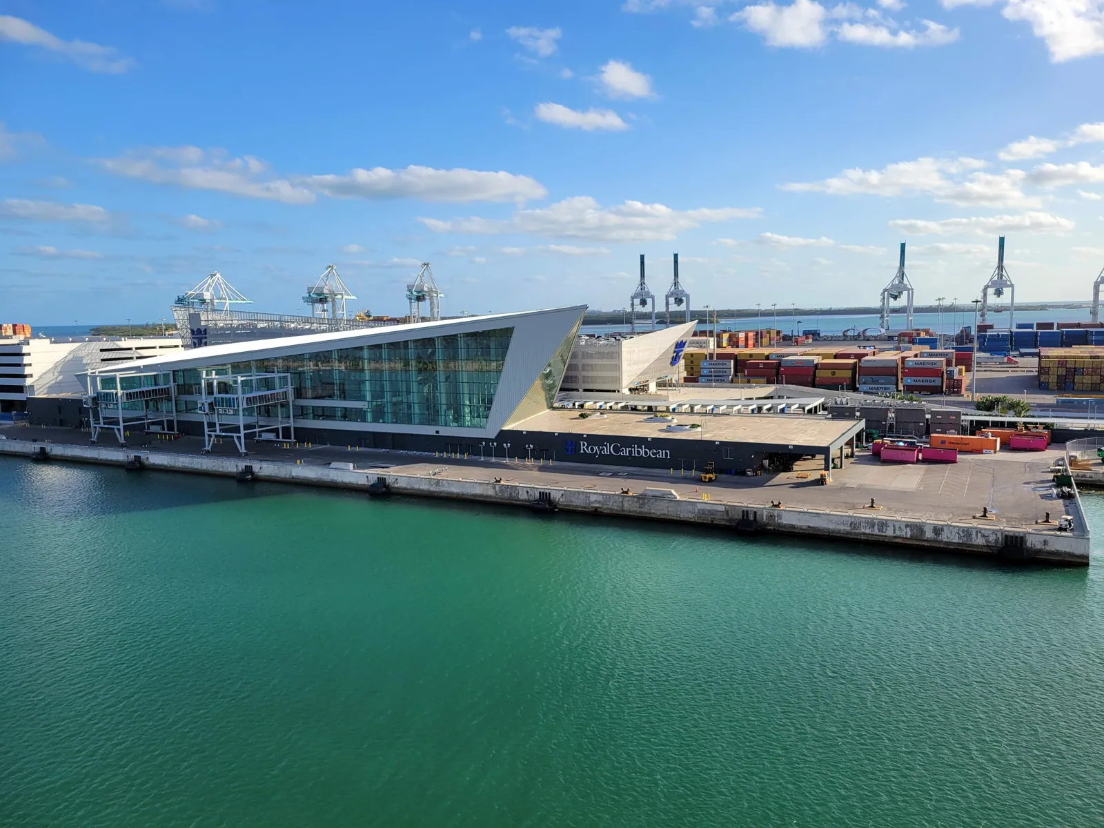 Royal Caribbean Terminal A at PortMiami, with its glass facade and waterfront berth