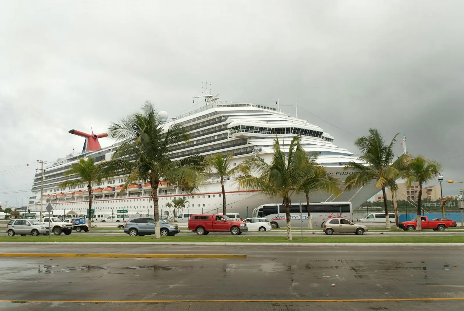 Cruise ship beside a passenger terminal and transfer roadway