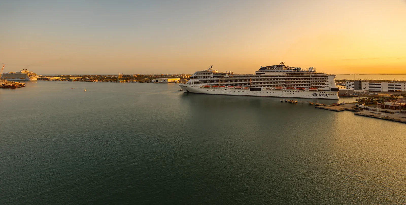 Cruise ships docked at Port Canaveral beside the harbor at sunset
