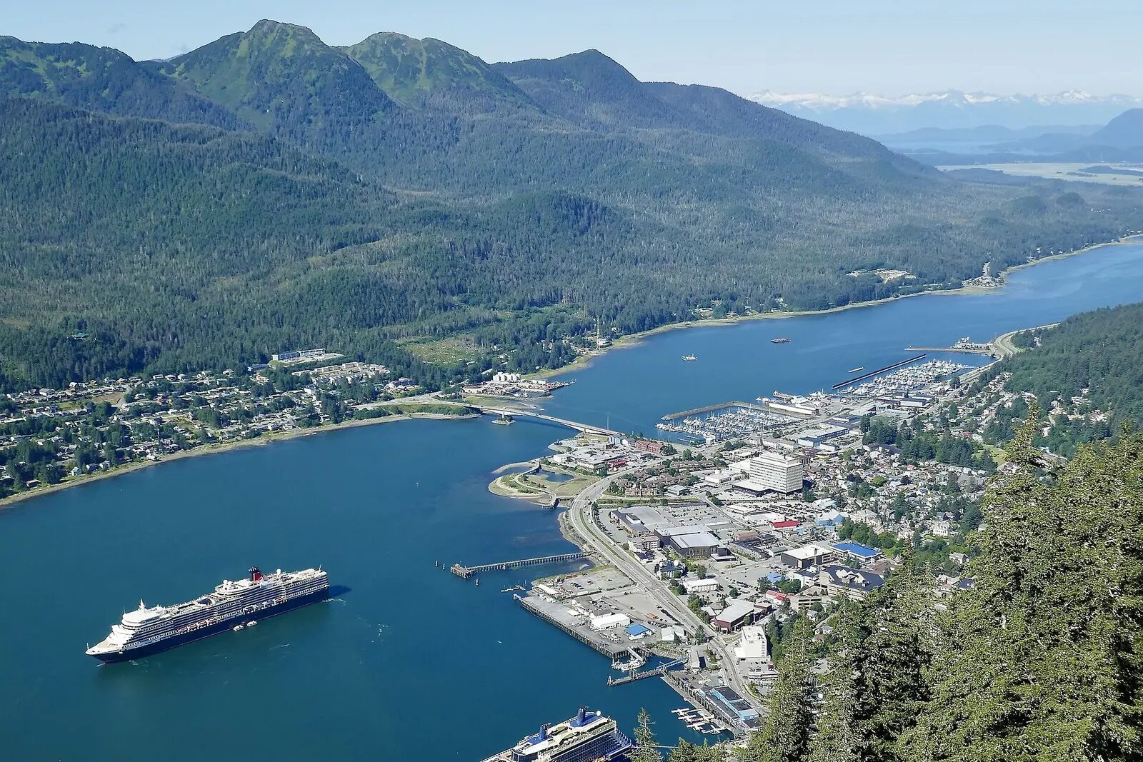 Cruise ship beside the mountain-lined waterfront of Juneau, Alaska